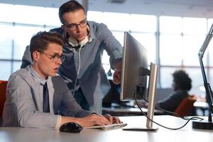 Two Business People Working With computer in office photo