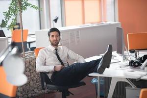 relaxed young business man at office photo