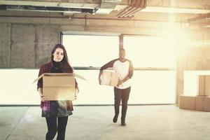 multiethnic business team carrying cardboard boxes photo