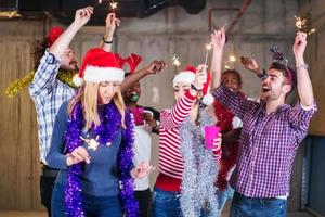 multiethnic group of casual business people dancing with sparklers photo