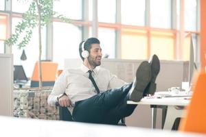 relaxed young business man at office photo