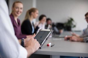 close up of  businessman hands  using tablet on meeting photo