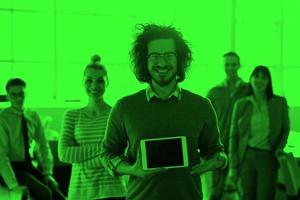 Portrait of a young businessman holding tablet photo