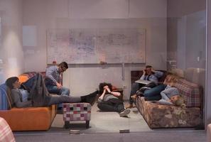 software developers sleeping on sofa in creative startup office photo