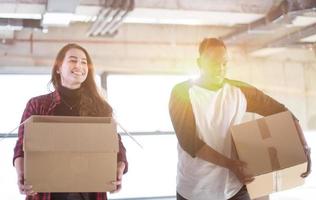 multiethnic business team carrying cardboard boxes photo