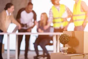 plant in flowerpot on cardboard box at new office photo