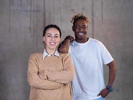 retrato de un equipo de negocios multiétnico informal frente a un muro de hormigón foto