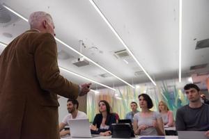 teacher with a group of students in classroom photo