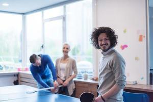 startup business team playing ping pong tennis photo