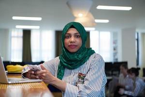 african muslim business woman using mobile phone photo