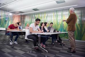 teacher with a group of students in classroom photo