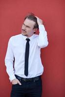 portrait of startup businessman in front of pink wall photo