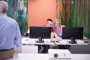 teacher and students in computer lab classroom photo