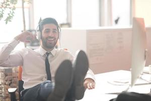 relaxed young business man at office photo