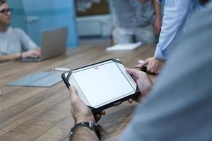 close up of businessman on meeting using tablet photo