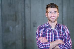 portrait of casual businessman in front of a concrete wall photo