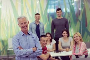 portrait of  teacher with students group in background photo