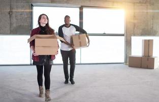 multiethnic business team carrying cardboard boxes photo