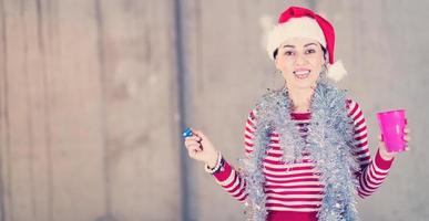 young business woman wearing a red hat and blowing party whistle photo