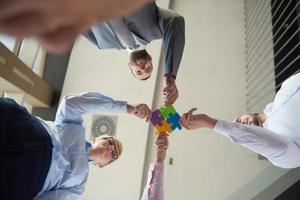 business people group assembling jigsaw puzzle photo