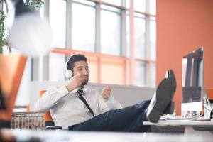 relaxed young business man at office photo