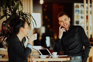 two young people on a break from work in a cafe take a break from everyday obligations. photo