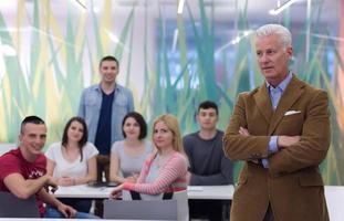 portrait of  teacher with students group in background photo