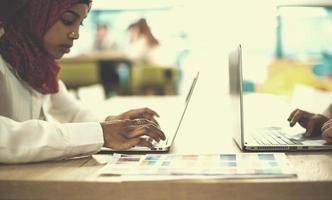 black muslim business woman ,working on laptop computer photo