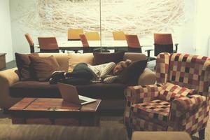 woman sleeping on a sofa  in a creative office photo