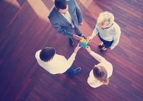 business people group assembling jigsaw puzzle photo