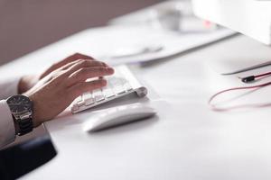 hands typing on desktop computer photo