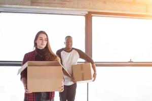 multiethnic business team carrying cardboard boxes photo