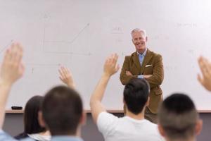 teacher with a group of students in classroom photo