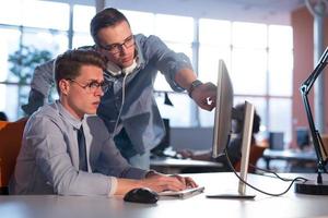 Two Business People Working With computer in office photo