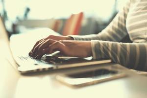 businesswoman using a laptop in startup office photo