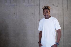 portrait of black businessman in front of a concrete wall photo