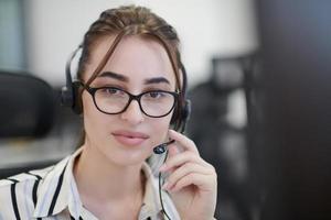 Business woman with headsets at work photo