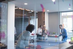 startup business team playing ping pong tennis photo