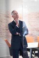 portrait of handsome senior business man at modern office photo