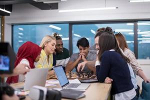 multiethnic group of business people playing chess photo
