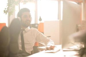 relaxed young business man at office photo