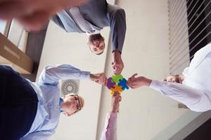 business people group assembling jigsaw puzzle photo