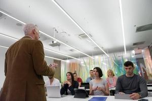 teacher with a group of students in classroom photo