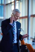 hombre de negocios senior habla por teléfono móvil foto