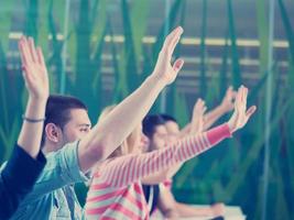 students group raise hands up on class photo