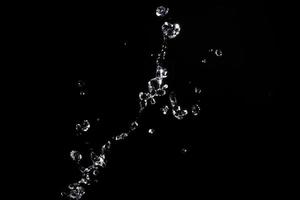 Water splash shot in studio, white water and black background, pure water for drink and food concept copy space for text and design photo