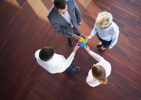 business people group assembling jigsaw puzzle photo