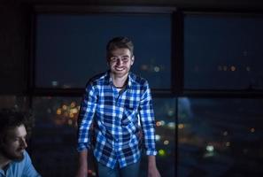 business people on construction site  in new startup office at night photo