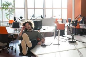 businessman sitting with legs on desk photo