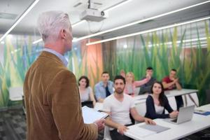 teacher with a group of students in classroom photo